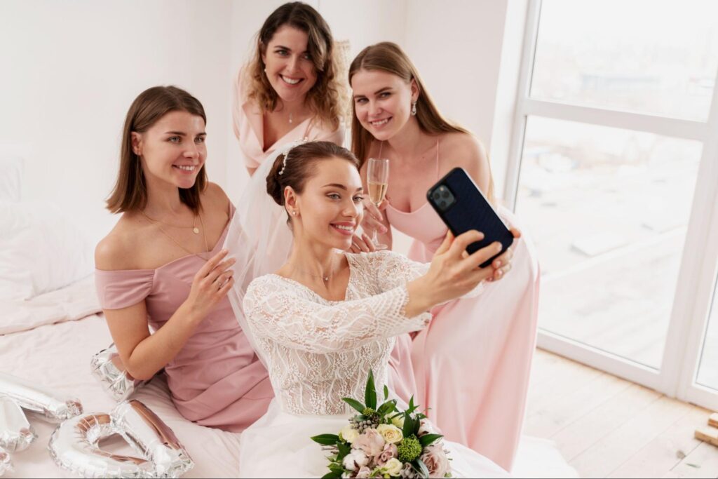 The bride takes a picture with her friends before the wedding